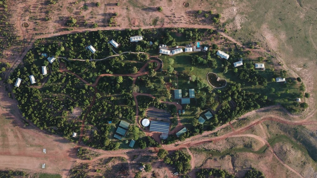 Aerial view of Fothergill Island camp, showing the tented suites, pool and solar array set among mopane woodland on Lake Kariba's shore