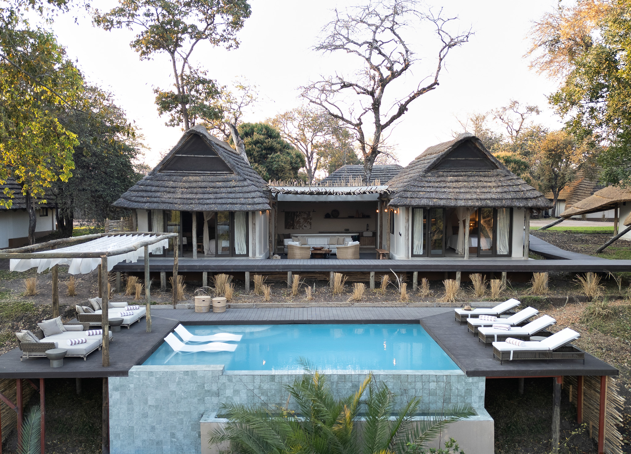 Thatched guest chalets at Lolelunga Private Reserve on the Lunga River, northern Zambia